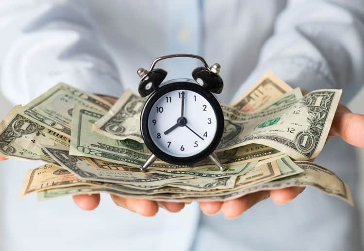 Man Holding Clock And Money