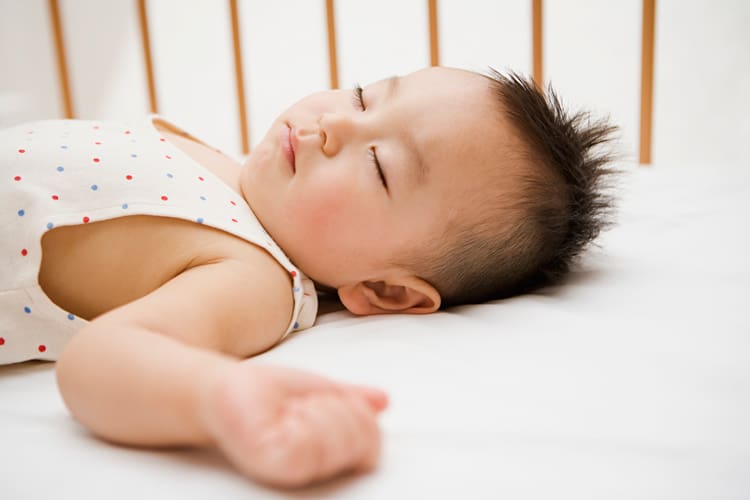 Boy Sleeping In Crib