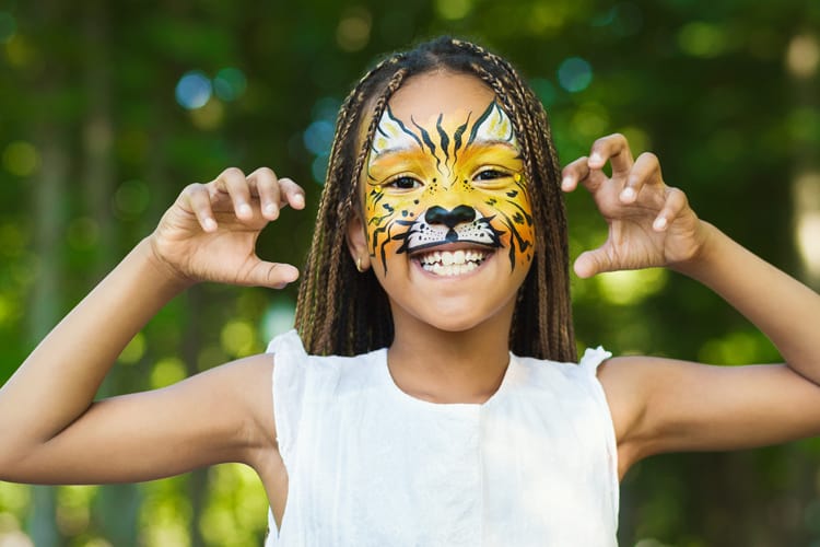 Pretty Girl With Tiger Face Painting For Halloween At The Zoo