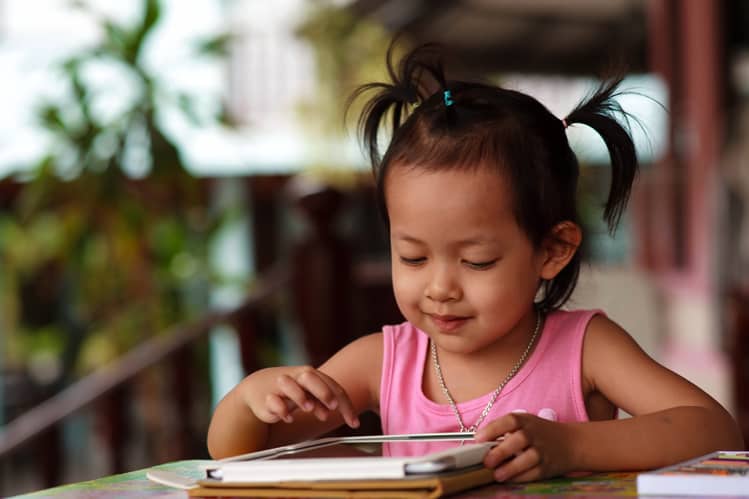 Girl Playing Tablet On Family Vacation