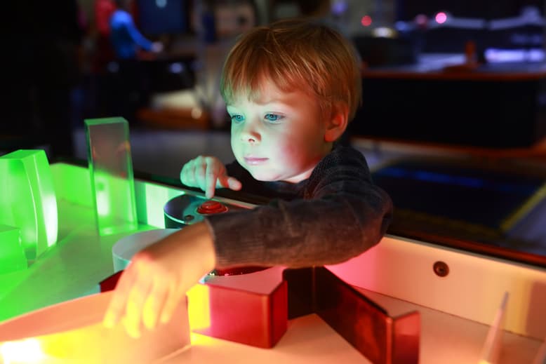 Little Boy Playing At A Museum On Family Vacation