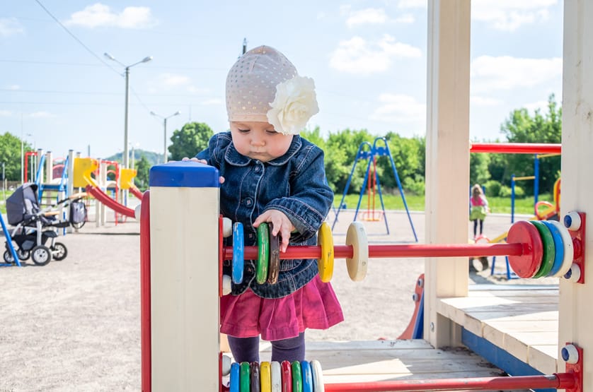 Little Girl Playing At Playground On A Pit Stop For Family Vacation