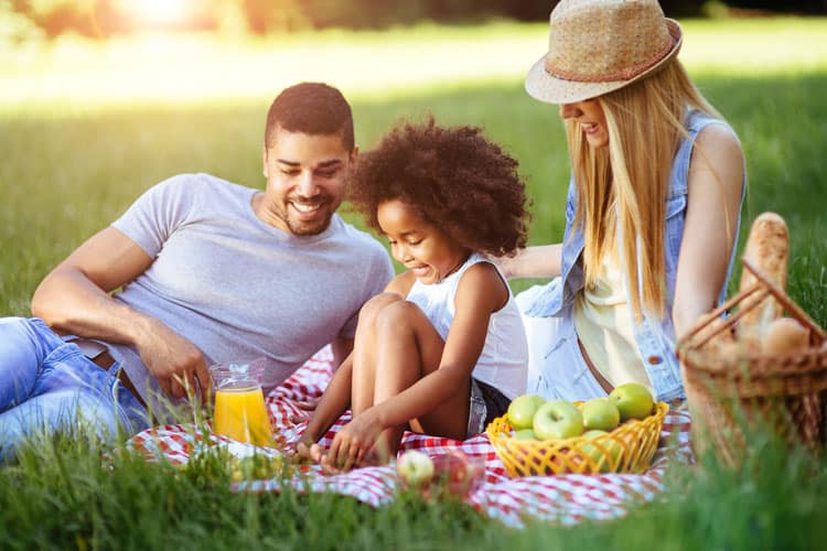 Family Eating A Picnic Lunch In San Francisco