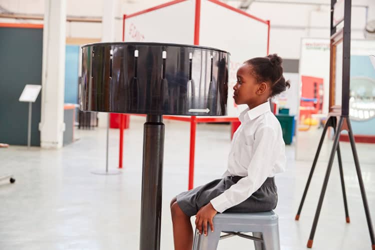 Girl Watching Zoetrope At Children'S Museum