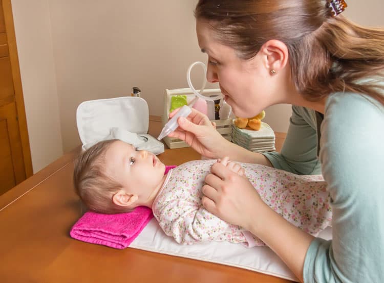 Mom Using Nose Frida On Her Baby Daughter