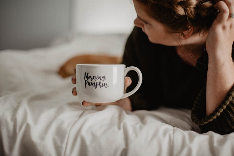 Mama Practicing Self-Care With Coffee In Bed