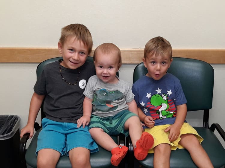 Happy Children Sitting On Chairs