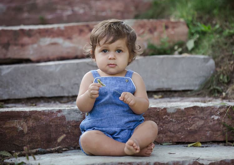 Baby Happily Sitting On Steps