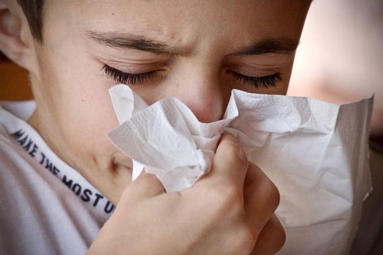 boy blowing his nose