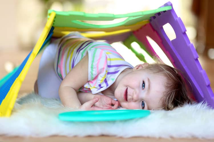 Little Girl Crawling Through Obstacle Course