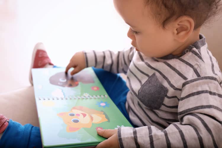 Child Reading Book From Subscription Box