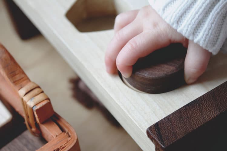 Child Playing With A Montessori Method Toy