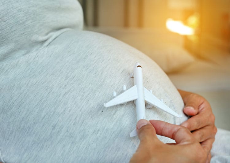 Woman Choosing A Babymoon Destination