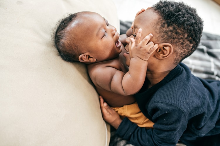 Little Boy Kissing Baby Brother