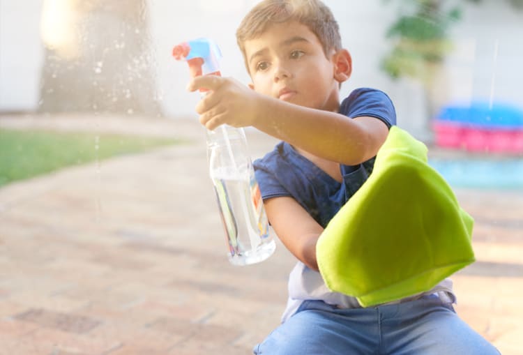 Child Cleaning The Window