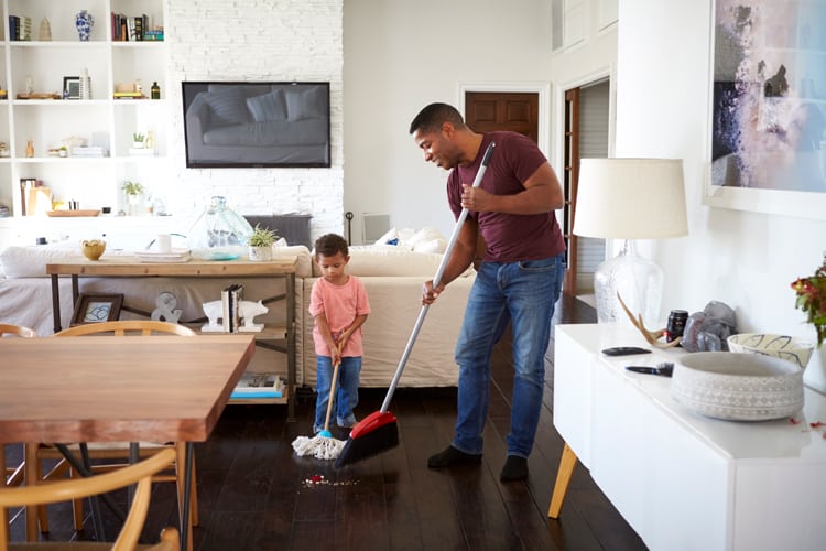 Father Teaching His Child To Clean