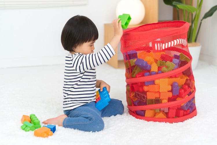 Child Picking Up Toys