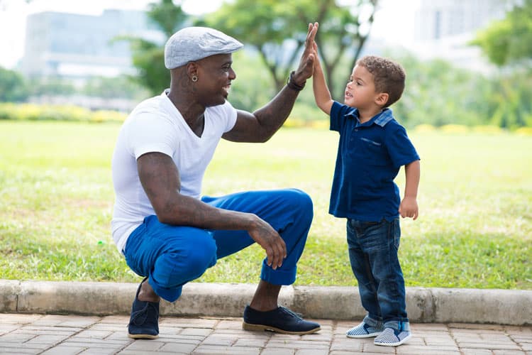 Father And Son Give Each Other High Five